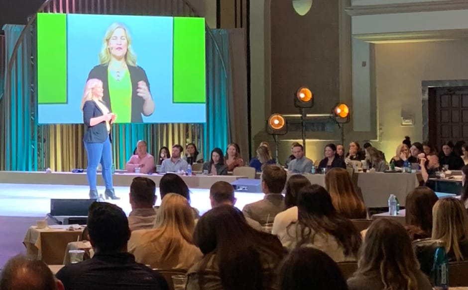 Deanna Moffitt speaking in front of a group of corporate clients